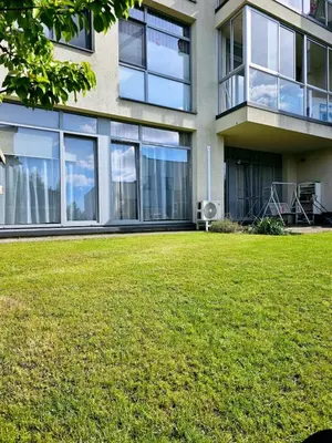 a building with a lawn in front of it at 3 rooms 3 beds apartment with garden in Kaunas