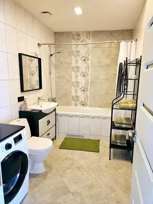 a bathroom with a toilet and a sink and a shower at 3 rooms 3 beds apartment with garden in Kaunas