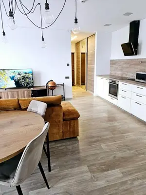 a living room with a couch and a table at 3 rooms 3 beds apartment with garden in Kaunas