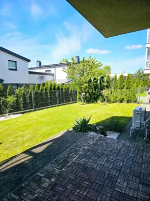 a backyard with a lawn and a fence at 3 rooms 3 beds apartment with garden in Kaunas