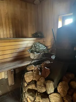 a room with a fire place with a pile of logs at Bijunai in Žaugėdai