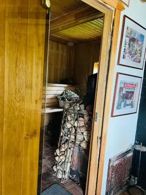 a door to a room with a pile of fire wood at Bijunai in Žaugėdai