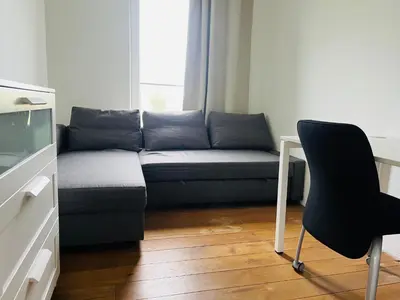 a living room with a couch and a chair at Bijunai in Žaugėdai