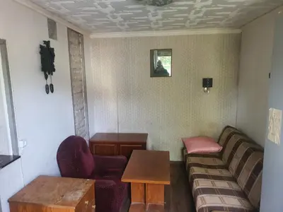 a living room with a couch and a table at Hostelis in Rudamina