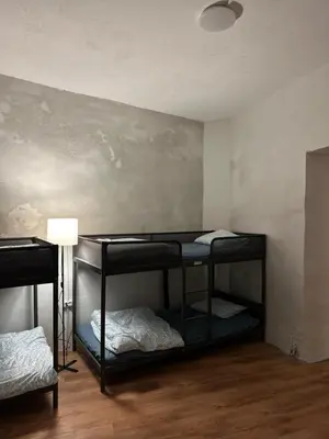 a room with two bunk beds in it with a wall at Gate of Dawn by Kliefs Vilnius - Virtual Check-In in Vilnius
