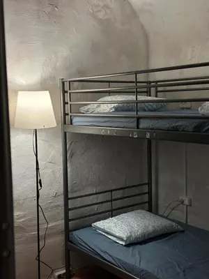 a room with three bunk beds with a lamp at Gate of Dawn by Kliefs Vilnius - Virtual Check-In in Vilnius