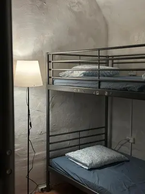 a room with three bunk beds and a lamp at Gate of Dawn by Kliefs Vilnius - Virtual Check-In in Vilnius