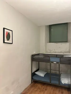a room with bunk beds and a flat screen tv at Gate of Dawn by Kliefs Vilnius - Virtual Check-In in Vilnius