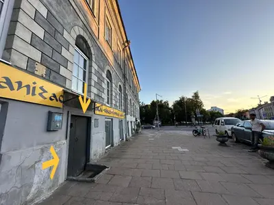 a building with a sign on the side of a street at Gate of Dawn by Kliefs Vilnius - Virtual Check-In in Vilnius