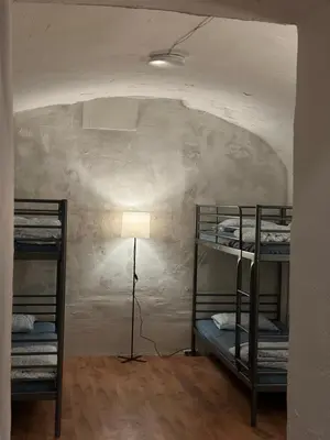 a room with two bunk beds and a lamp at Gate of Dawn by Kliefs Vilnius - Virtual Check-In in Vilnius