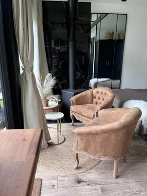 a living room with two chairs and a table at Vilnius river house in Dusinėnai