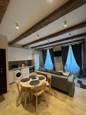 a living room with a couch and a table at BONUM apartments in Vilnius old town in Vilnius