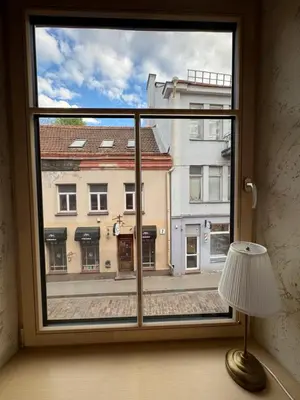 a window with a view of a city street at BONUM apartments in Vilnius old town in Vilnius