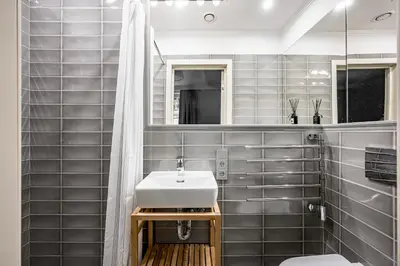 a bathroom with a sink and a mirror at Super Central Studio in Vilnius