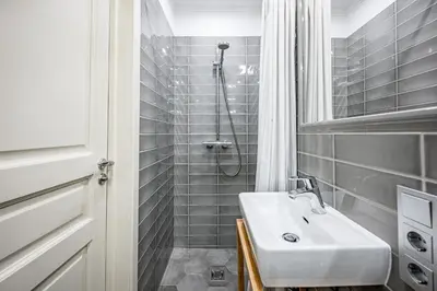 a bathroom with a sink and a shower at Super Central Studio in Vilnius