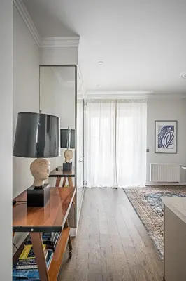 a living room with a table and a large window at Super Central Studio in Vilnius