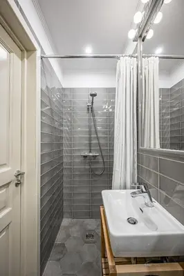 a bathroom with a sink and a shower at Super Central Studio in Vilnius