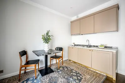 a kitchen with a table and chairs and a sink at Super Central Studio in Vilnius
