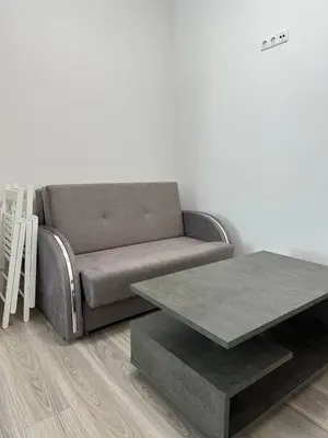 a living room with a couch and a table at Užupio Apartamentai Nemokamas parkingas 2 in Vilnius