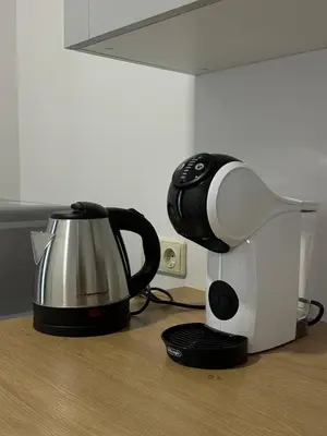 a coffee maker and a coffee pot on a counter at Užupio Apartamentai Nemokamas parkingas 2 in Vilnius