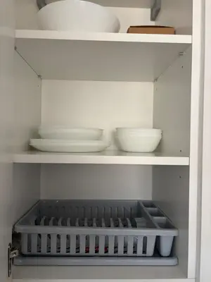 a shelf with plates and bowls on it at RR Apartments in Algirdo street in Vilnius