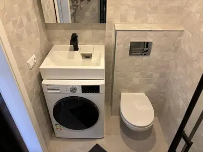 a small bathroom with a toilet and a sink at RR Apartments in Algirdo street in Vilnius