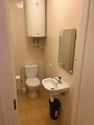 a small bathroom with a toilet and a sink at Linkmenų sporto ir rekreacijos centras in Linkmenys