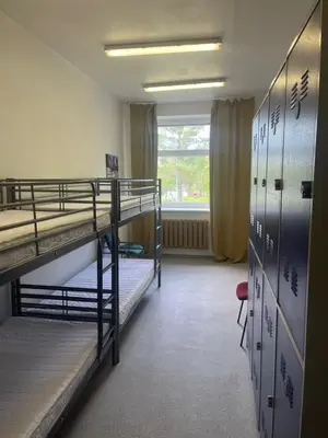 a dorm room with two bunk beds and a window at Linkmenų sporto ir rekreacijos centras in Linkmenys