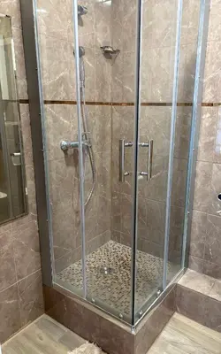 a shower stall with a glass shower door at Saulutė in Birštonas