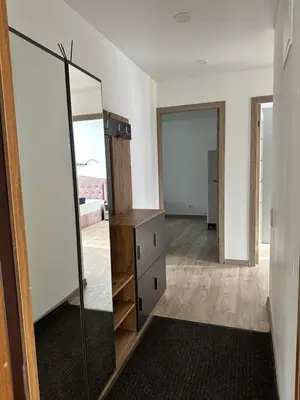 a dressing room with a mirror and a dresser at Lauros Apartamentai in Kupiškis