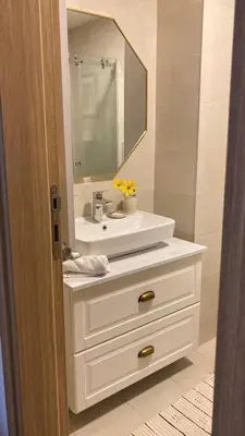 a bathroom with a white sink and a mirror at Kalinovs Stay Apartment in Adutiškis