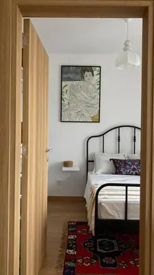 a bedroom with a bed and a picture on the wall at Kalinovs Stay Apartment in Adutiškis