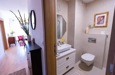 a white bathroom with a toilet and a sink at Kalinovs Stay Apartment in Adutiškis