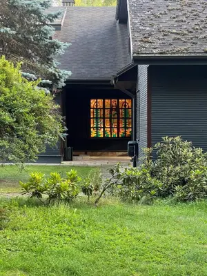 a house with a window on the front of it at Secluded private villa in the middle of the woods in Margionys