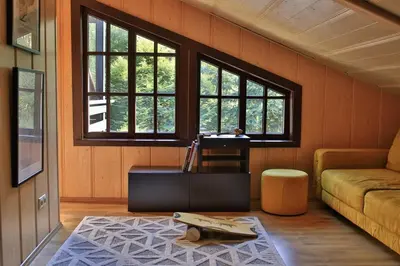 a living room with a couch and a table at Secluded private villa in the middle of the woods in Margionys