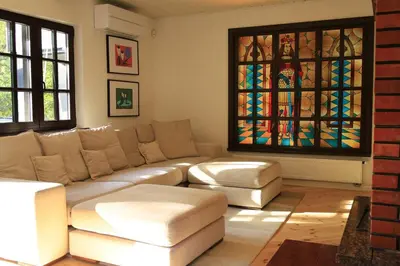 a living room with a couch and a stained glass window at Secluded private villa in the middle of the woods in Margionys