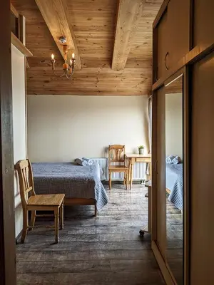 a bedroom with two beds and a table and chairs at Guest House Kamara in Panevėžys