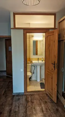 a bathroom with a sink and a toilet and a mirror at Guest House Kamara in Panevėžys