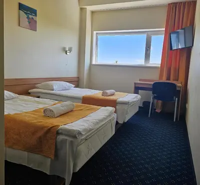 a room with three beds and a desk and a window at ----------------------------- Via Baltica Panevezys in Panevėžys