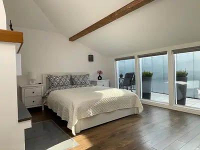 a bedroom with a bed and a balcony at newTown in Kaunas