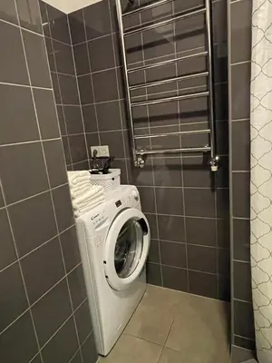 a washer and dryer in a small bathroom at newTown in Kaunas