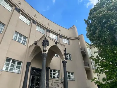 a building with a statue on the front of it at newTown in Kaunas