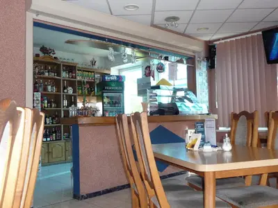 a dining room with a table and chairs in a restaurant at Skaistažiedė in Šiauliai