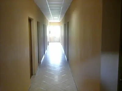 an empty hallway with a hallway leading to a window at Skaistažiedė in Šiauliai