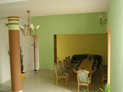 a dining room with a table and chairs at Skaistažiedė in Šiauliai