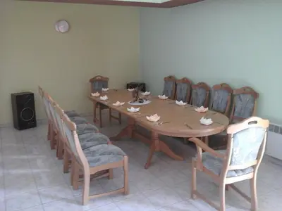 a dining room table with chairs and a wooden table at Skaistažiedė in Šiauliai