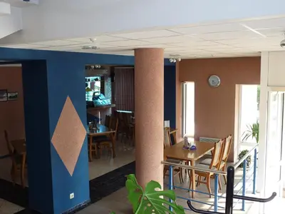 a dining room with a table and chairs at Skaistažiedė in Šiauliai
