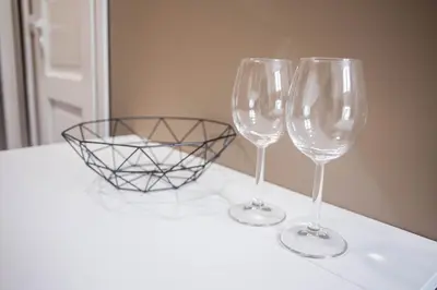 two wine glasses and a basket on a counter at Hostel K3a in Vilnius