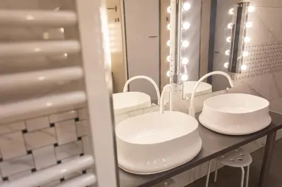 a bathroom with two sinks and a mirror at Hostel K3a in Vilnius
