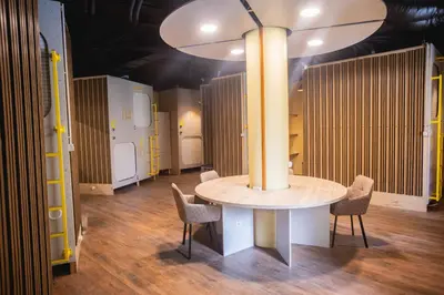 a room with a table and chairs and a large light at Hostel K3a in Vilnius